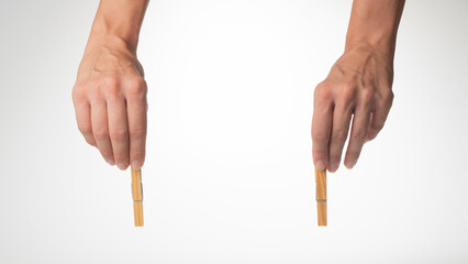 woman's hands on top hold clothespins to fasten the background for the inscription
