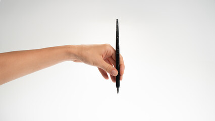 women's left hand holds a calligraphy pen on a white background, gesture drops into the inkwell, lefty