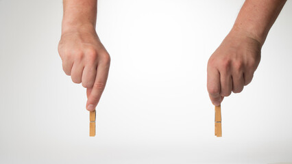 Men's hands on top hold clothespins to fasten the background for the inscription