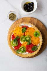Overhead view of quiche with cheese and tomatoes