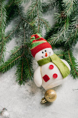 Fototapeta na wymiar Christmas composition with snowman and green branches decorations top