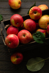 Fresh apples in wooden crate harvest fruits on rustic surface homegrown food