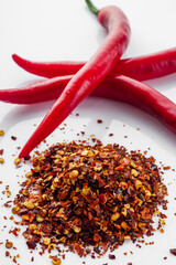 spicy chili flakes on a white background