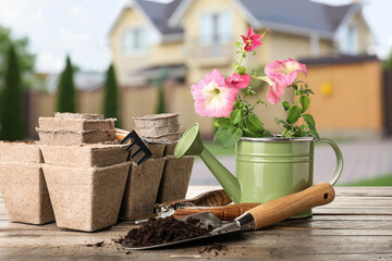 Set of gardening supplies on table outdoors