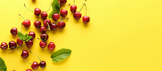 Tasty cherries on yellow background with space for text, top view