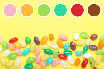 Sweet candies on yellow background. Different color patterns