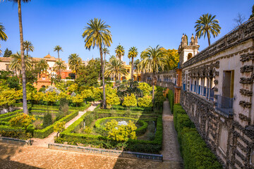 Beautiful formal public garden inside Alcazar Seville palace in summertime in Andalusia