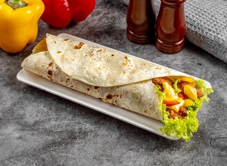 Salted Egg Crispy Chicken shawarma Wrap served in a cutting board on grey background side view of...