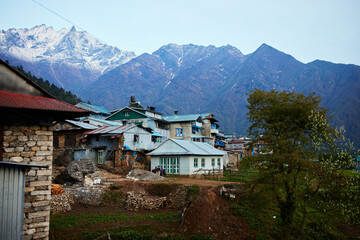 Fototapeta na wymiar a mountain view at Lukla nepal of normal houses in nepalese country side on the mountain everest base camp trek green travel activities