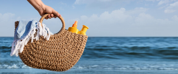 Woman with beach bag near sea. Banner for design