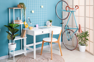 Interior of stylish office with workplace and bicycle