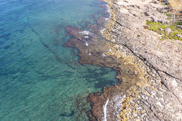 Aerial view of waves splashing on beach
