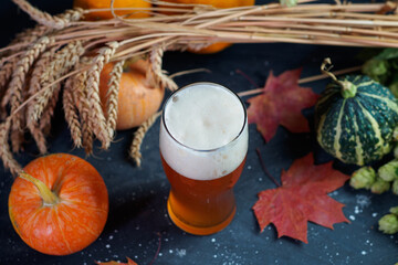 Oktoberfest concept and craft pumpkin autumn beer. Harvest on the table and a glass of fresh ale