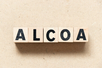 Alphabet letter block in word ALCOA (Abbreviation of Attributable, Legible, Contemporaneous, Original and Accurate)  on wood background