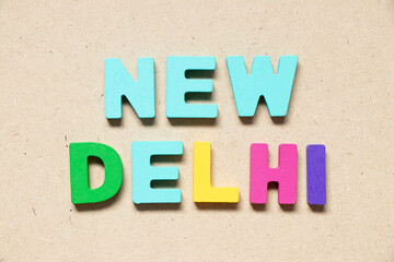 Color alphabet letter in word new delhi on wood background