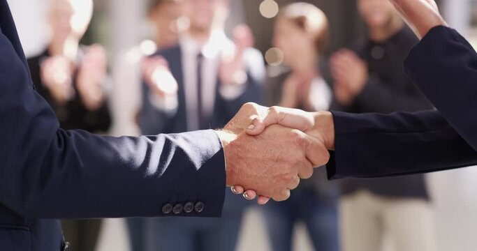 Handshake, agreement and partnership between business people meeting and greeting. Closeup of corporate or political leaders handshaking after a successful deal outside with applause from an audience