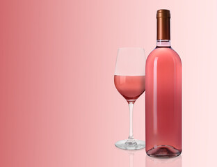 Bottle and glass of delicious rose wine on pink background. Space for text