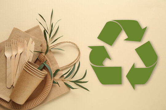 Flat lay composition with eco friendly products and recycling symbol on beige background