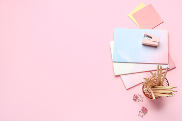 Set of different stationery on pink background