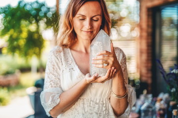 Beautiful woman holding the natural protection crystal.