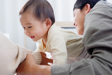 Fototapeta premium Father and son lie down and play with happy smiles.