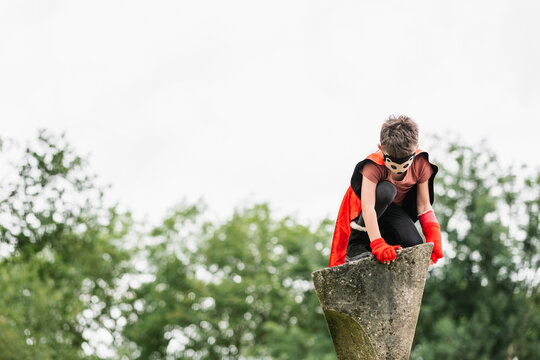 Superhero in hedgehog mask in park