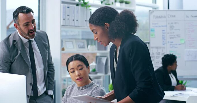 Modern group of smart office workers showing teamwork while working on a team presentation together. Diverse corporate executive workers planning a meeting. Digital coordinators talking about tech