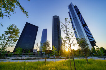 Four business skyscrapers of the business district at sunset in Madrid, Spain.