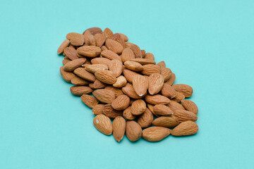 Almond nuts on a green background