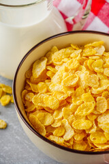crispy golden cornflakes on a gray concrete background