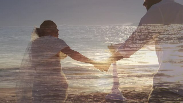 Animation of sea over married african american couple at beach