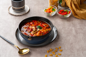 Minestrone Soup is a thick soup of Italian origin made with vegetables, often with the addition of pasta or rice.