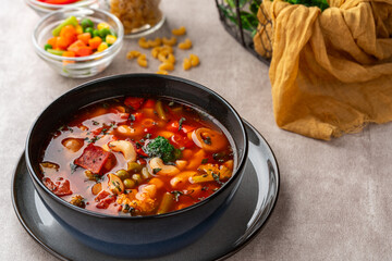 Minestrone Soup is a thick soup of Italian origin made with vegetables, often with the addition of pasta or rice.
