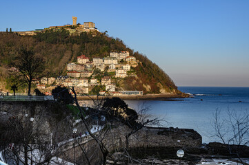 view of mount igueldo de san sebastián at dawn you can see the houses of the lighthouse under the...
