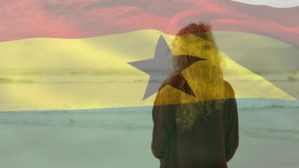 Animation of flag of ghana over caucasian woman at beach - Powered by Adobe