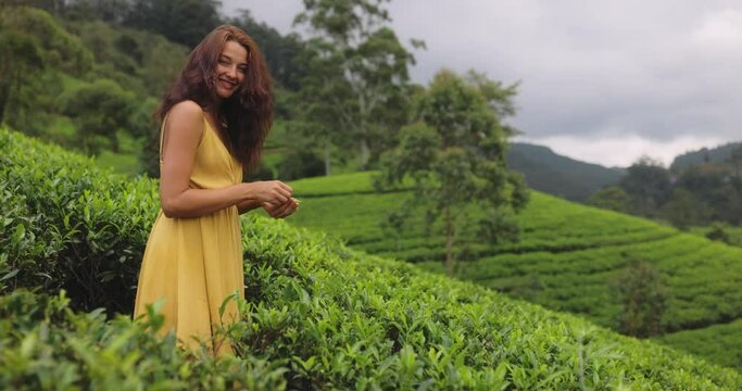 Traveler Woman With Tea Leaf in Hand During Her Travel to Famous