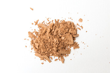 Close up of neutral beige make up cosmetic powder sprinkle on white background. Aesthetic minimalist beauty branding, merchandise concept