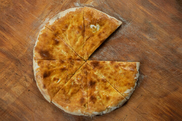 Baked homemade  cheese pie on wooden background. Bulgarian banitsa, Georgian khachapuri, Greek tiropita