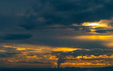 smoke from the chimney of a nuclear power plant at sunset