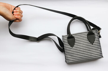 hand holding beautiful and elegant black and white patterned handbag