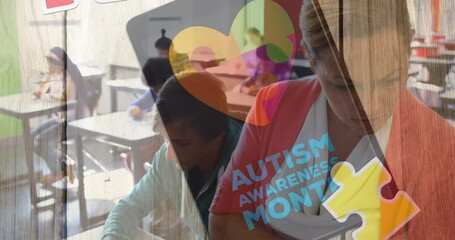 Animation of autism awareness month text over diverse schoolchildren and teacher using tablet - Powered by Adobe