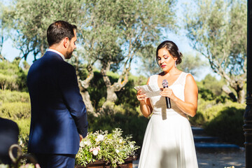 Groom and bride read vows during their wedding