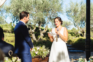 Groom and bride read vows during their wedding - Powered by Adobe
