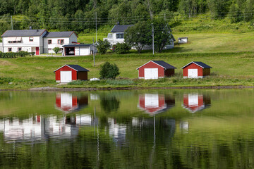 Fototapeta na wymiar a beautiful Rorbu on a fjord in northern norway, typical fishermen's houses, Finnmark, Norway
