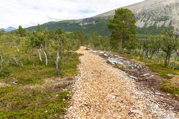 Plakat path leading to the Blue Lake Blavatnet (Blåisvannet Blåvatnet) in Lyngen Alps in Norway travel destinations
