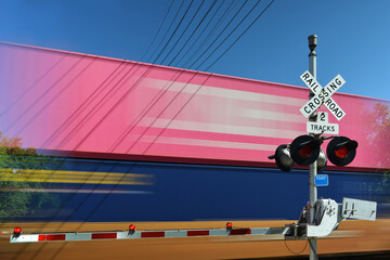 Blurred freight train in motion at crossing gate