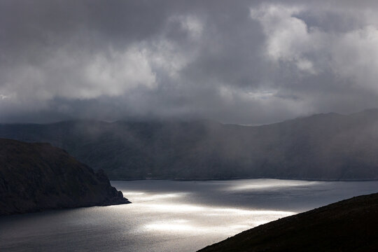 beautiful sunbeams in a Norwegian fjord. Dramatic sky over the mountains of Norway