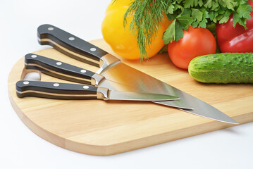 Chopping board with tomato, cucumber, parsley and knife