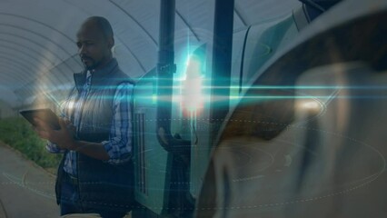 Animation of light trails over african american businessman using tablet - Powered by Adobe