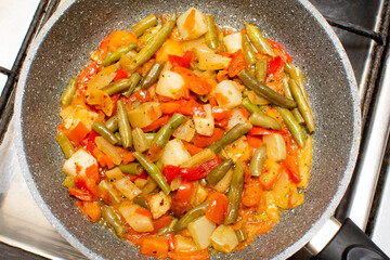 diet vegetable mixture is heated in a frying pan